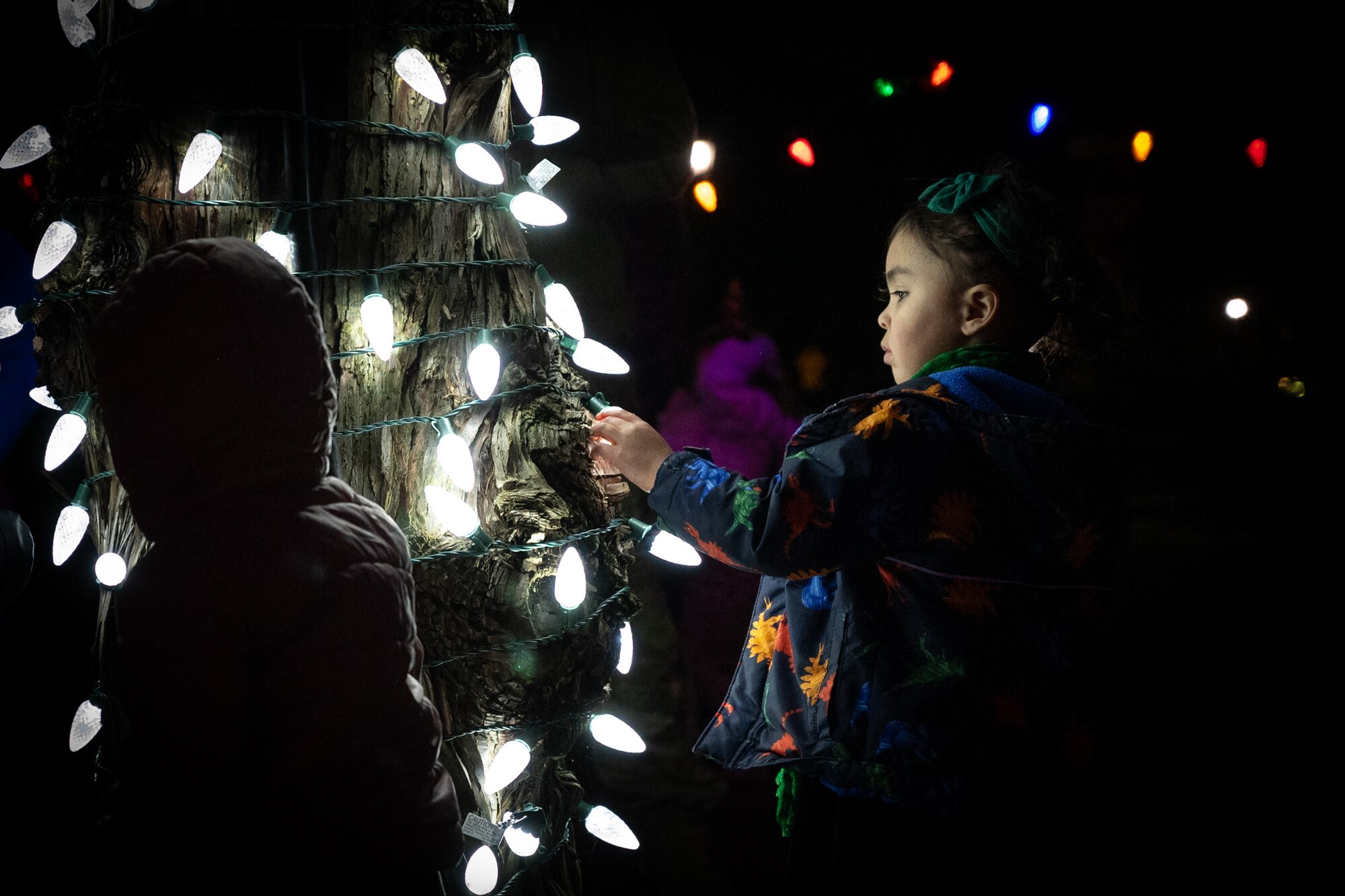 A child inspects the holiday lights after the annual Team McChord holiday tree lighting ceremony at Joint Base Lewis-McChord, Washington, Dec. 5, 2024.