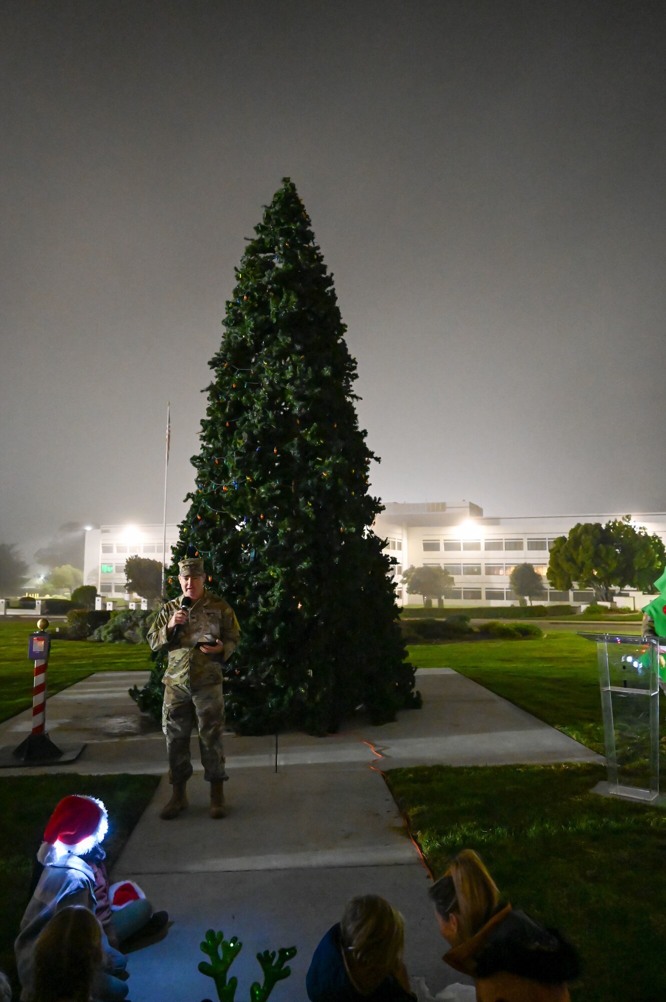Col. Shoemaker stands in front of the Christmas tree.