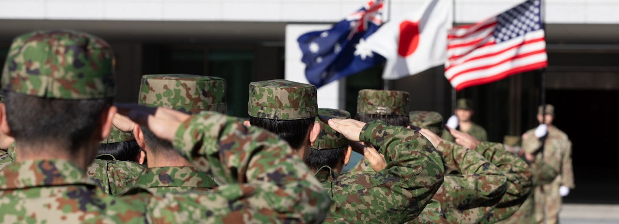 Service members of the Japan Ground Self-Defense Force salute the national flags during the opening ceremony of Yama Sakura 87 at Camp Asaka, Japan, Dec. 6, 2024.
