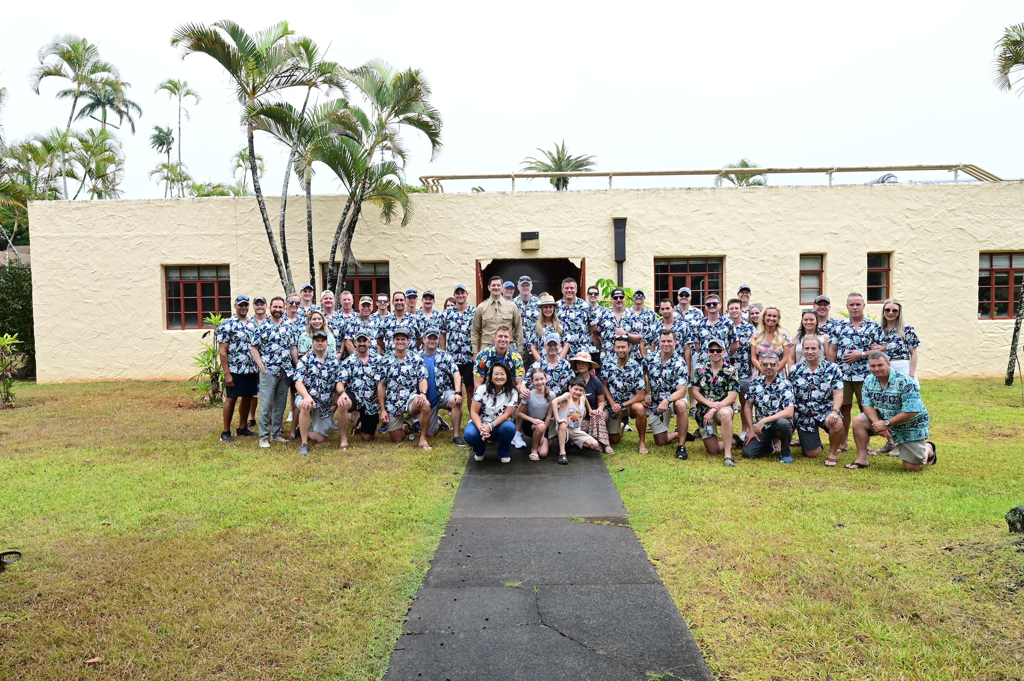 A-10 Thunderbolt II pilots from the 47th Fighter Squadron take a group photo in front of the building that lodged the two officers, Lieutenants Kenneth Taylor and George Welch, who were a part of the first to take action when the Japanese launched their surprise attack on Pearl Harbor, during Rim of the Pacific 2024 in Hawaii, July 27, 2024. Taylor and Welch were members of the then 47th Pursuit Squadron and while at RIMPAC 2024 the now 47th Fighter Squadron pilots were afforded the opportunity to learn where their true legacy began in 1941. (U.S. Air Force Photo by MSgt Courtney Richardson)