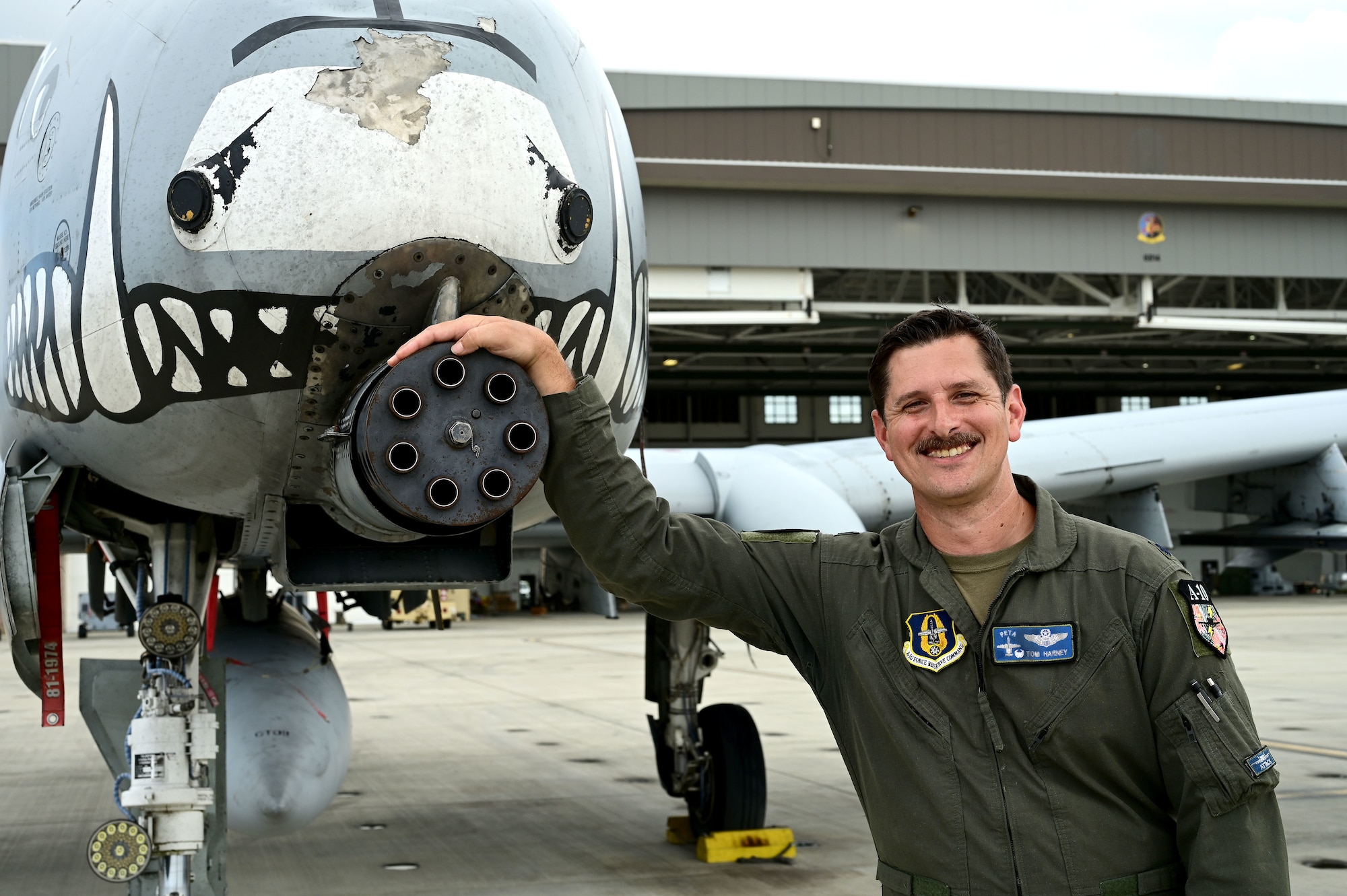 Lt. Col. Tom Harney, 47th Fighter Squadron commander with 18 years of A-10 experience, poses for a photo in front next to the A-10 Thunderbolt II gatling gun during the unit’s participation in Rim of the Pacific (RIMPAC) 2024 in Hawaii, July 30, 2024. The 47th Fighter Squadron is deactivating making RIMPAC 2024 the last time their A-10s will participate. However, Harney found it special and meaningful to bring the 47th Fighter Squadron back to the island, celebrating 83 years of tactical excellence and honoring the unit's historical achievements. (U.S. Air Force Photo by MSgt Courtney Richardson)