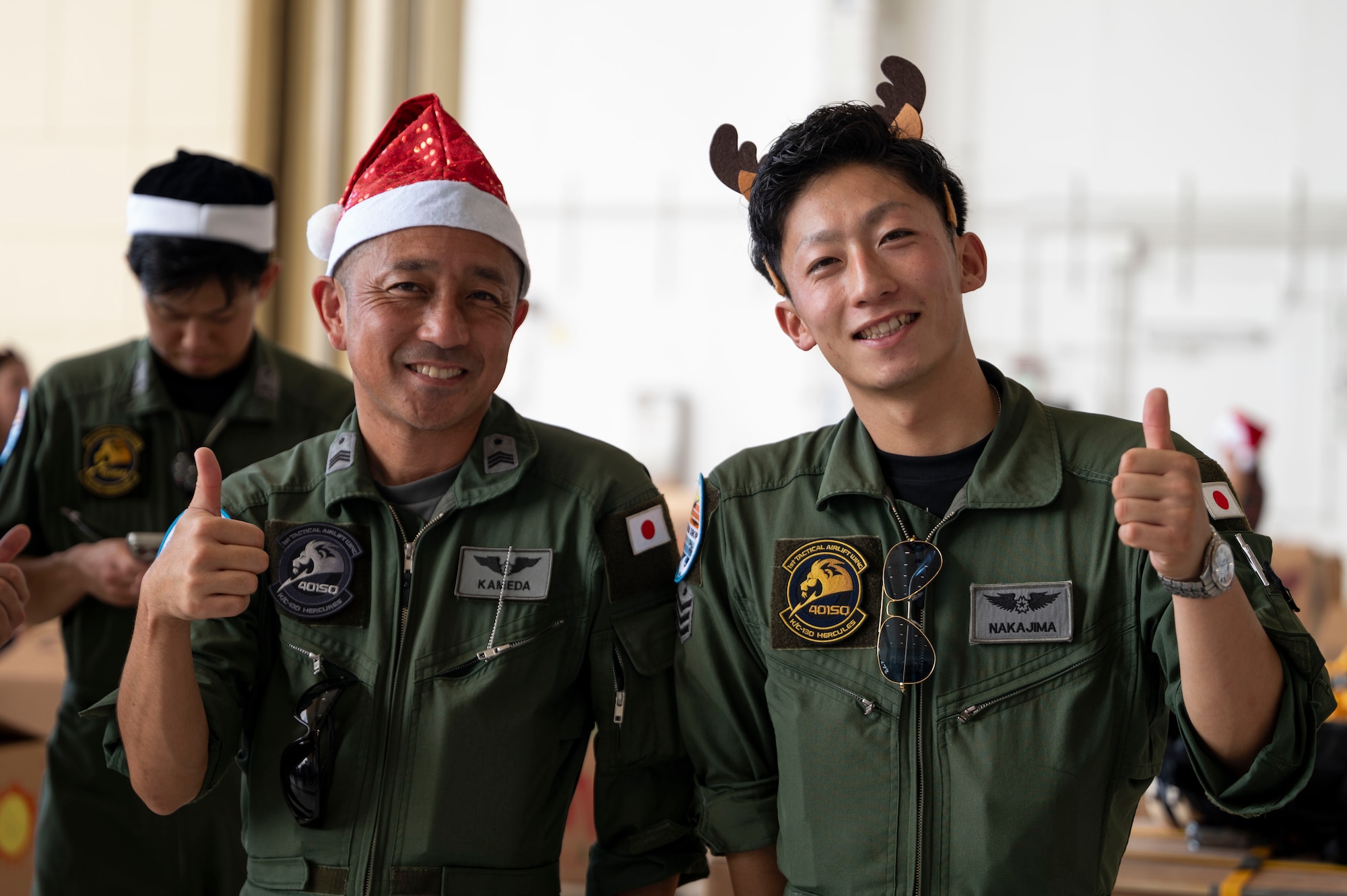 Service members and volunteers from different corners of the Pacific theater gathered in Hangar 5 to pack boxes with supplies, including canned goods, clothing, school items, toys and more Dec. 7.