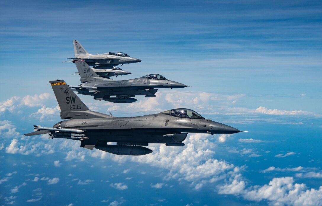 U.S. Air Force F-16 Fighting Falcons and Philippine Air Force FA-50s fly over the Philippine Sea