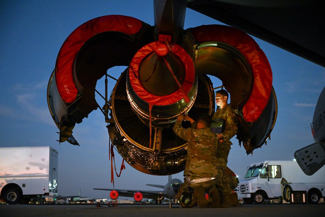Airmen working on a engine.