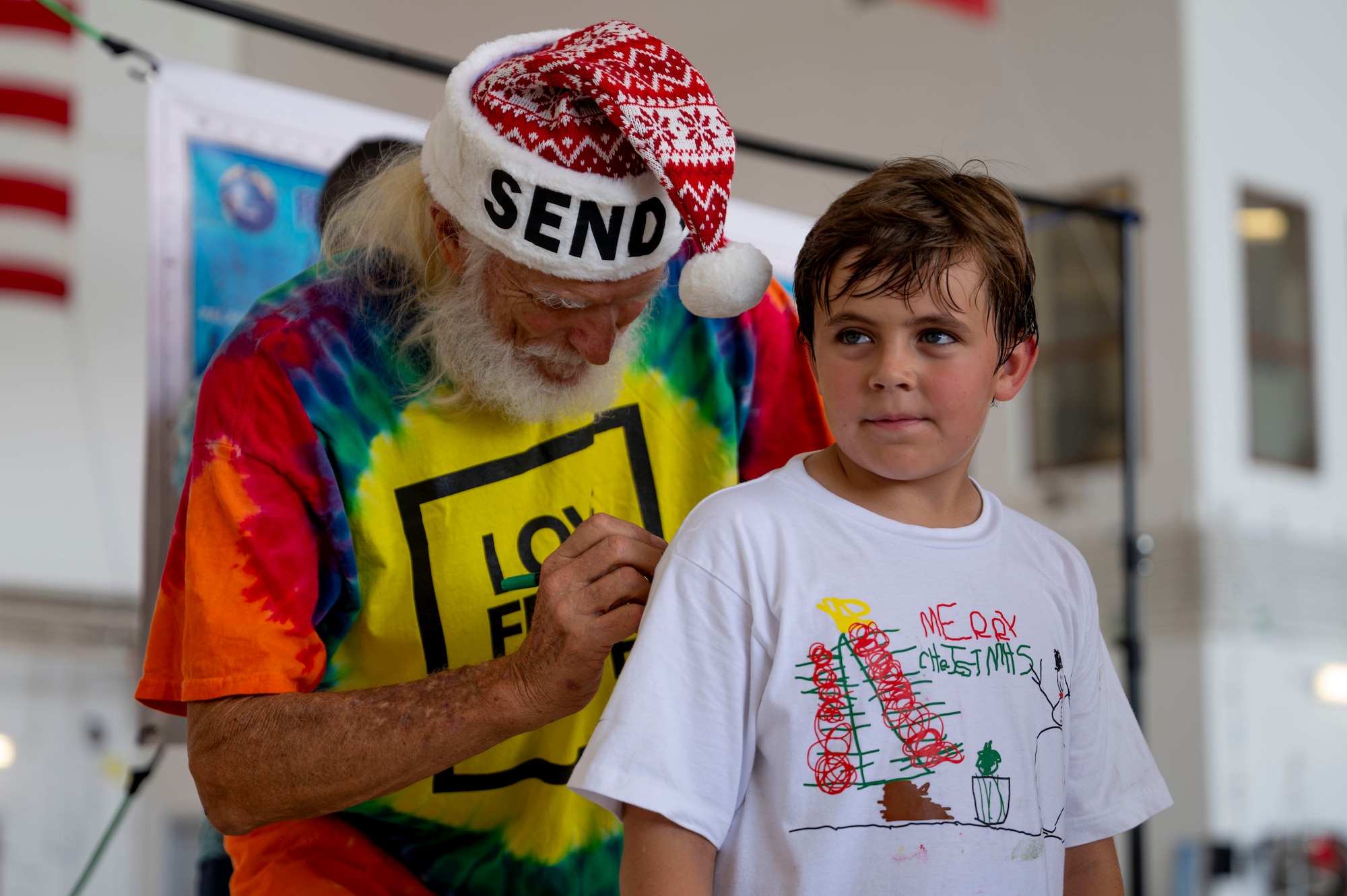 Service members and volunteers from different corners of the Pacific theater gathered in Hangar 5 to pack boxes with supplies, including canned goods, clothing, school items, toys and more Dec. 7.