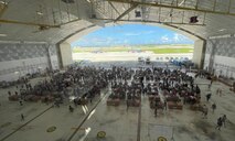 Service members and volunteers from different corners of the Pacific theater gathered in Hangar 5 to pack boxes with supplies, including canned goods, clothing, school items, toys and more Dec. 7.