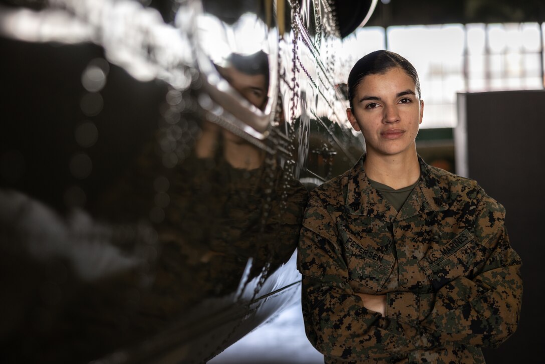 U.S. Marine Corps Sgt. Shelby Petersen, a vocalist with Marine Corps Quantico Band, poses next to a Boeing Vertol CH-46 Sea Knight at Marine Corps Air Facility Quantico, on MCBQ, Virginia, Dec. 3, 2024. Petersen, a Kalispell, Montana native, enlisted as an Aviation Ordnance Systems Technician in the year 2020, and submitted for a lateral move in 2023 to her current military occupational specialty. “If it’s a dream of yours, don’t give up on it,” Petersen said definitively. “No matter where you are in life, whatever opportunities you get or lack-thereof, it’s really important to take the time for the things that make you feel alive and make your soul feel whole.” (U.S. Marine Corps photo by Lance Cpl. Braydon Rogers)