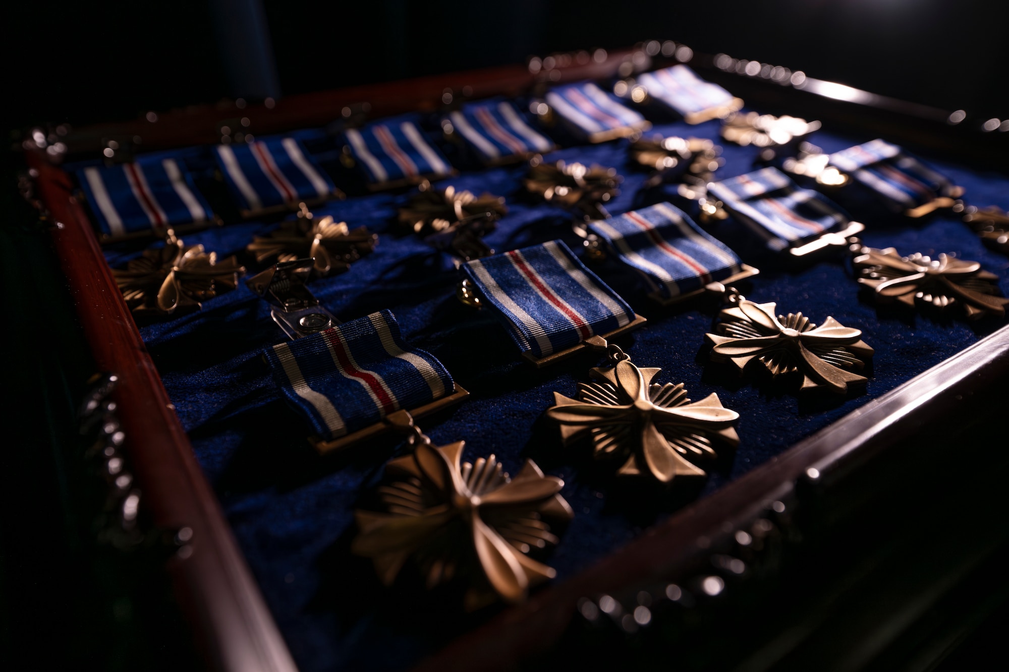 Eleven Distinguished Flying Cross medals lay on a table before a ceremony on McGhee Tyson Air National Guard Base, Knoxville, Tennessee, December 7,2024.