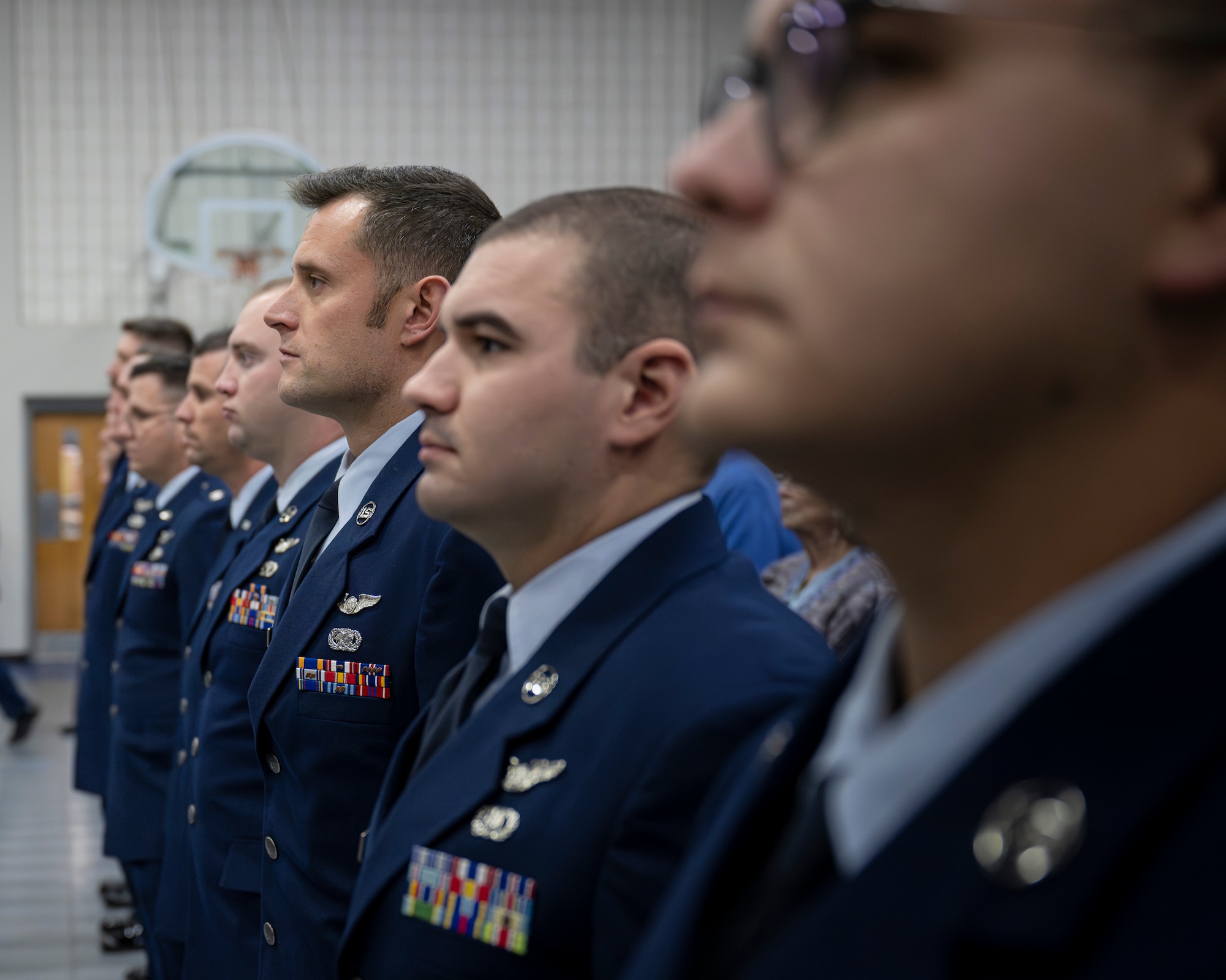 Eleven Airmen from the 134th Air Refueling Wing stand before receiving the Distinguished Flying Cross during a ceremony at McGhee Tyson Air National Guard Base, Knoxville, Tennessee, December 7, 2024.