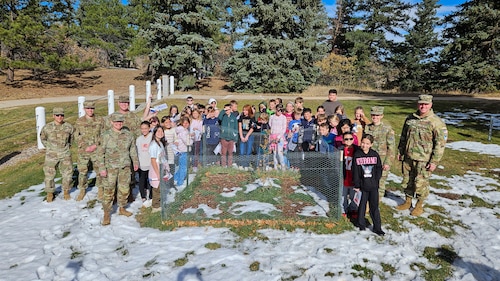Personnel from the U.S. Air Force Academy and Space Training and Readiness Command's Space Detachment 1, along with fifth-grade students from Pikes Peak School of Expeditionary Learning, gather beside the Academy's first Artemis Moon Tree following its plaque unveiling ceremony at the Academy in Colorado Springs, Colorado, Nov. 16, 2024. Notable attendees include U.S. Air Force Brig. Gen. Linell A. Letendre, Dean of the Faculty (third from left); Maj. Lucia White, Academy instructor (second from right); and Col. Marc Sands, Commander of Space Detachment 1 (far right), whose collaborative efforts were instrumental in bringing the Moon Tree to the Academy. (Courtesy photo)