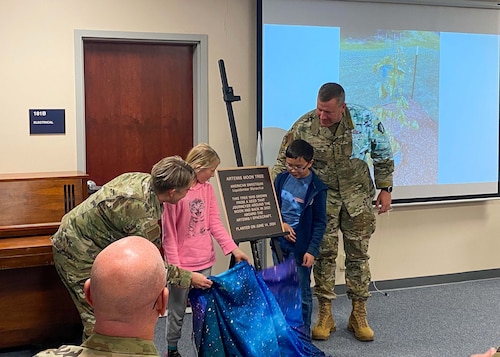 Lt. Gen. Tony Bauernfeind, right, the U.S. Air Force Academy’s 22nd Superintendent, and Brig. Gen. Linell A. Letendre, Dean of the Faculty, are joined by students from the Pikes Peak School of Expeditionary Learning as they unveil a plaque for the Academy's first Artemis Moon Tree during a ceremony at the Academy in Colorado Springs, Colorado, Nov. 15, 2024.