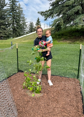 U.S. Space Force Maj. Lucia White, an Air Force Academy instructor, stands with her child beside the Academy's first Artemis Moon Tree planted near the U.S. Air Force Academy Planetarium in Colorado Springs, Colorado, June 15, 2024.