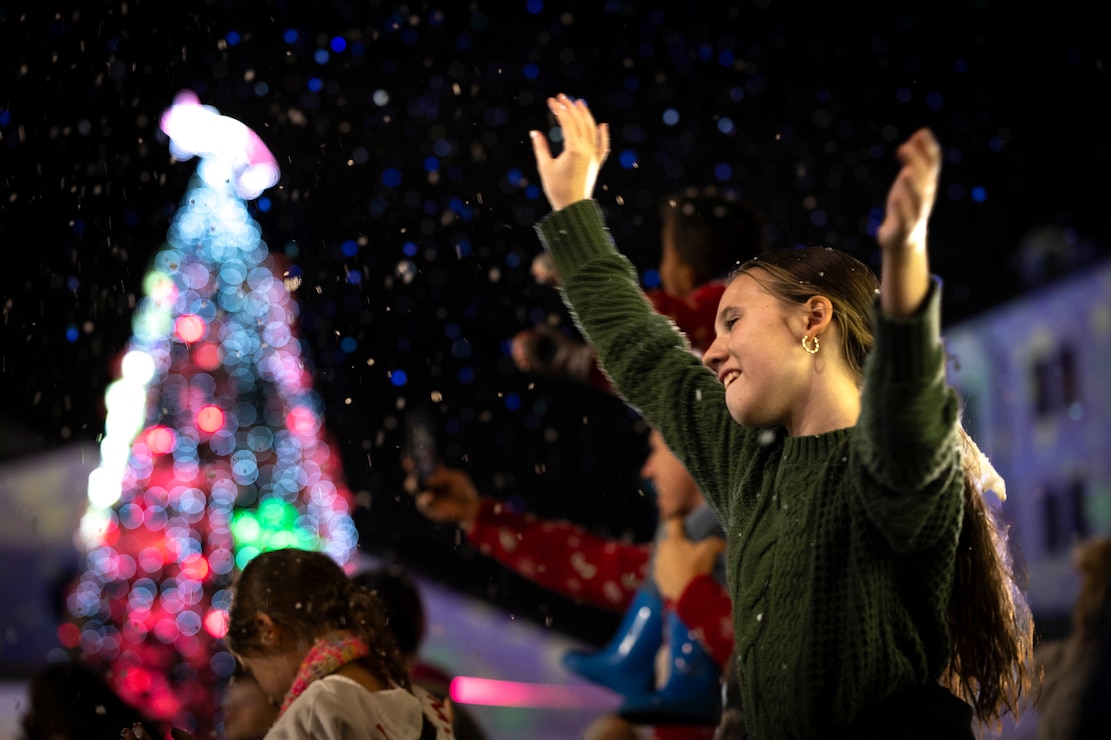 241205-N-WB673-6794 NAVAL SUPPORT ACTIVITY NAPLES, Italy (December 5, 2024) Attendees celebrate during an annual holiday Tree Lighting Event organized by U.S. Naval Support Activity (NSA) Naples, Italy Dec. 4, 2024. The event, often considered as an “unofficial” kick-off to the holiday season was attended by Capt. John Randazzo, base commander, Vittorio Lettieri, Mayor of Gricignano, children from a foster home in the nearby town of Trentola Ducenta and over 2,000 service members and families from various commands including NATO.  NSA Naples is an operational ashore base that enables U.S., allied, and partner nation forces to be where they are needed, when they are needed to ensure and stability in the European, African, and Central Command areas of responsibility. (U.S. Navy photo by Mass Communication Specialist 1st Class Haydn N. Smith)