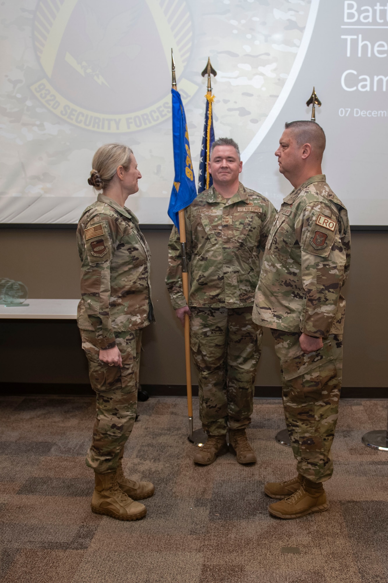 Col. Dori Mansur, 923nd Mission Support Group commander, passes the guidon to, Maj. George Mokriakow, incoming 932nd Logistics Readiness Flight commander during the assumption of command on Dec. 7, 2024, Scott Air Force Base, Illinois. (U.S. Air Force Photo by SSgt Brooke Spenner)
