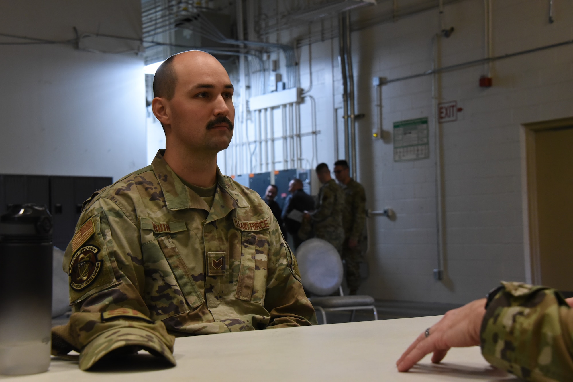 Staff Sgt. Ethan Druin, 185th Air Refueling Wing Security Forces, sits at a desk