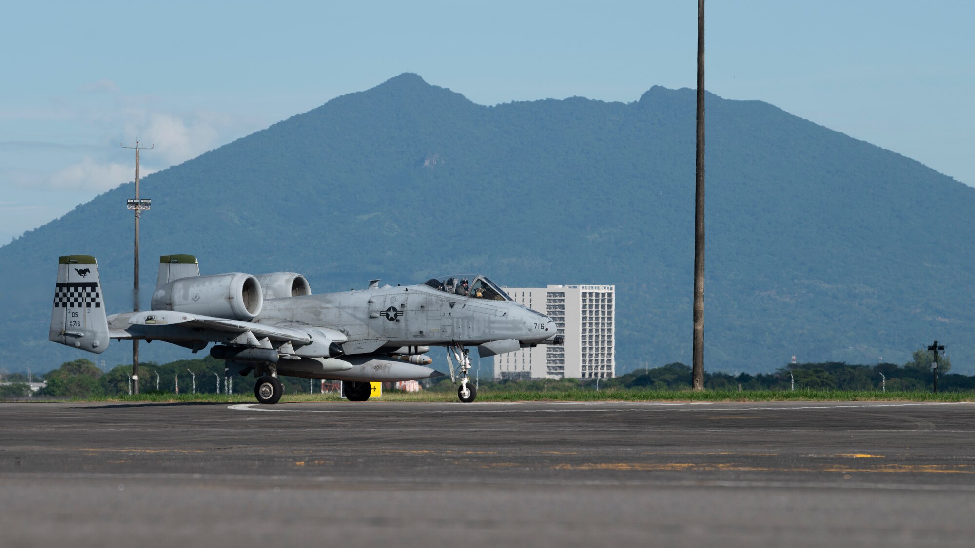 An A-10 fighter jet lands on a runway