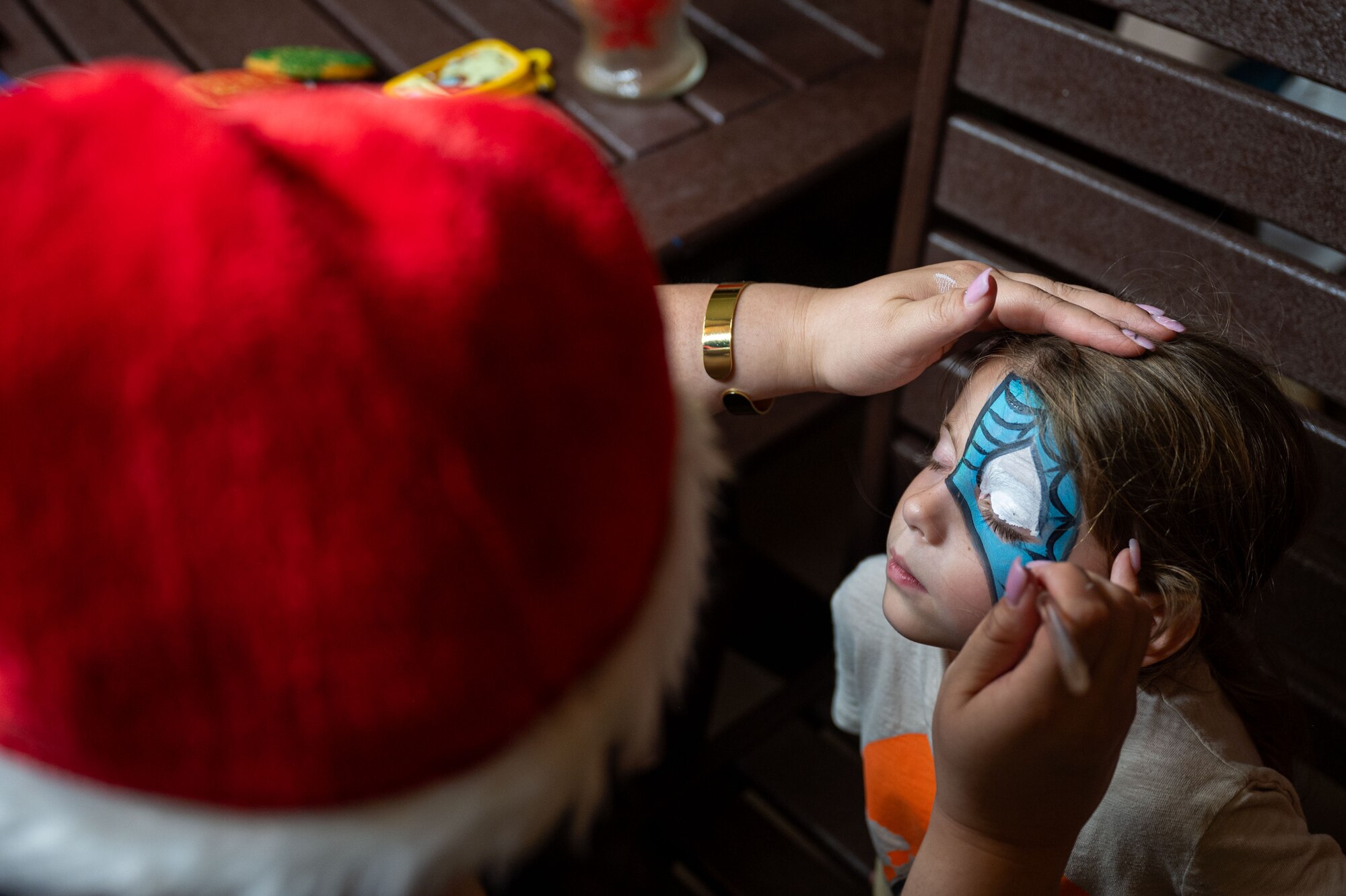Family and friends rallied together at the Tree Lighting Ceremony to celebrate the start of the holiday season by meeting Santa and enjoying live music, face painting, games and more. (U.S. Air Force photo by Airman 1st Class Audree Campbell)
