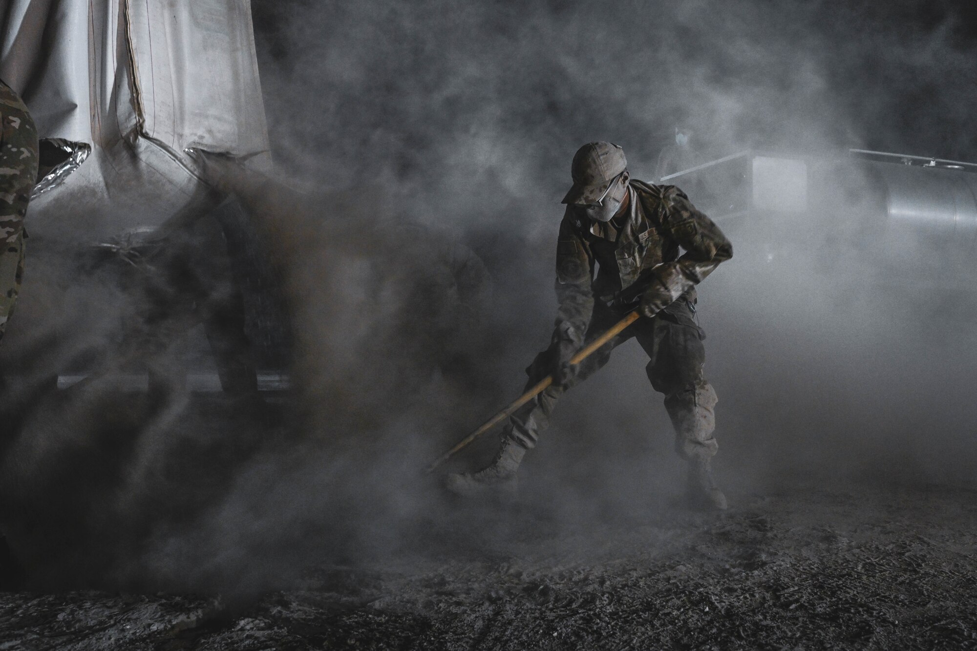 An Airman mixes concrete during an exercise.