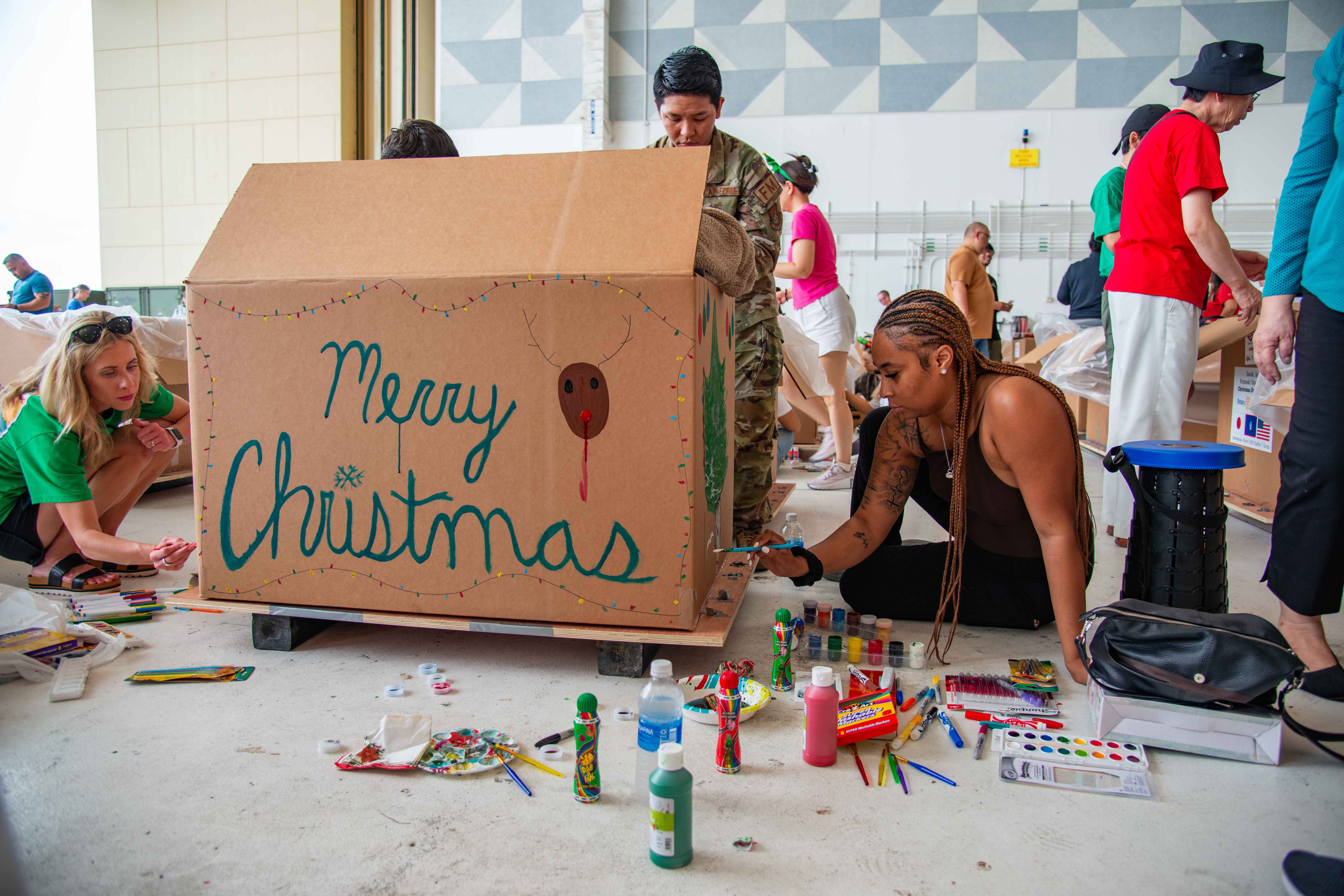 Volunteers decorate a box during the 73rd Operation Christmas Drop box build event at Andersen Air Force Base, Guam, Dec. 6, 2024.