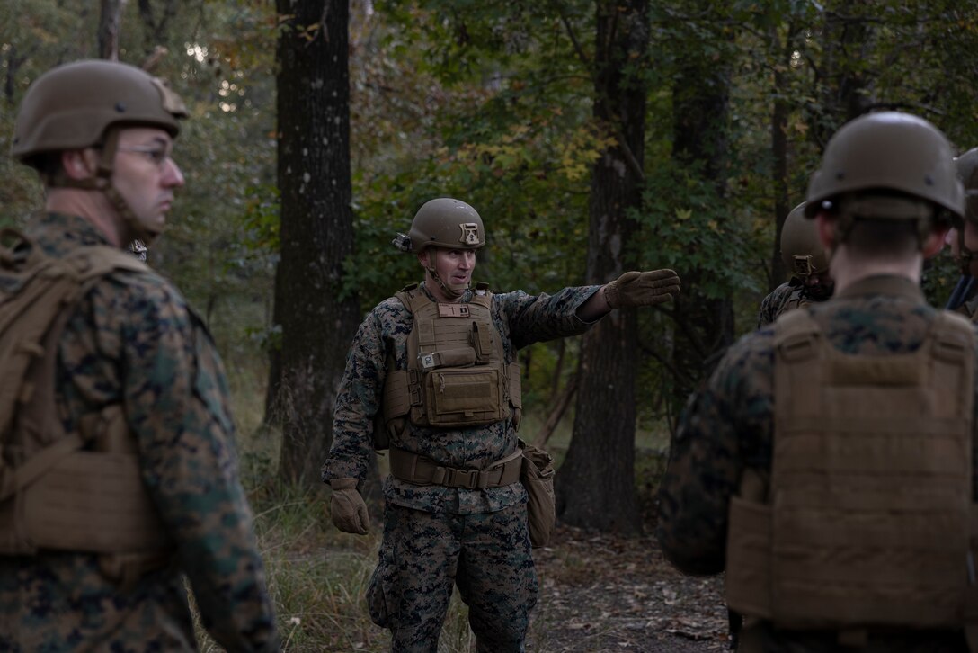 U.S. Navy Lt. Jamin M. Bailey, the battalion chaplain of 2d Reconnaissance Battalion, 2d Marine Division, gives orders to his squad during a simulated medical evacuation during the II Marine Expeditionary Force Religious Ministry Expeditionary Skills Training on Marine Corps Base Camp Devil Dog, North Carolina, Oct. 25, 2024. The II MEF Religious Ministry EST trained Chaplains and Religious Program Specialists to effectively execute tasks in an operational environment, through field training and classroom instruction presented by subject matter experts from 2d Marine Division. (U.S. Marine Corps photo by Lance Cpl. Alexandria Serrano)