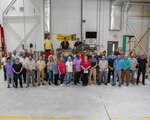 FRCE and DLA employees stand in front of the depot’s final completed F402 engine.