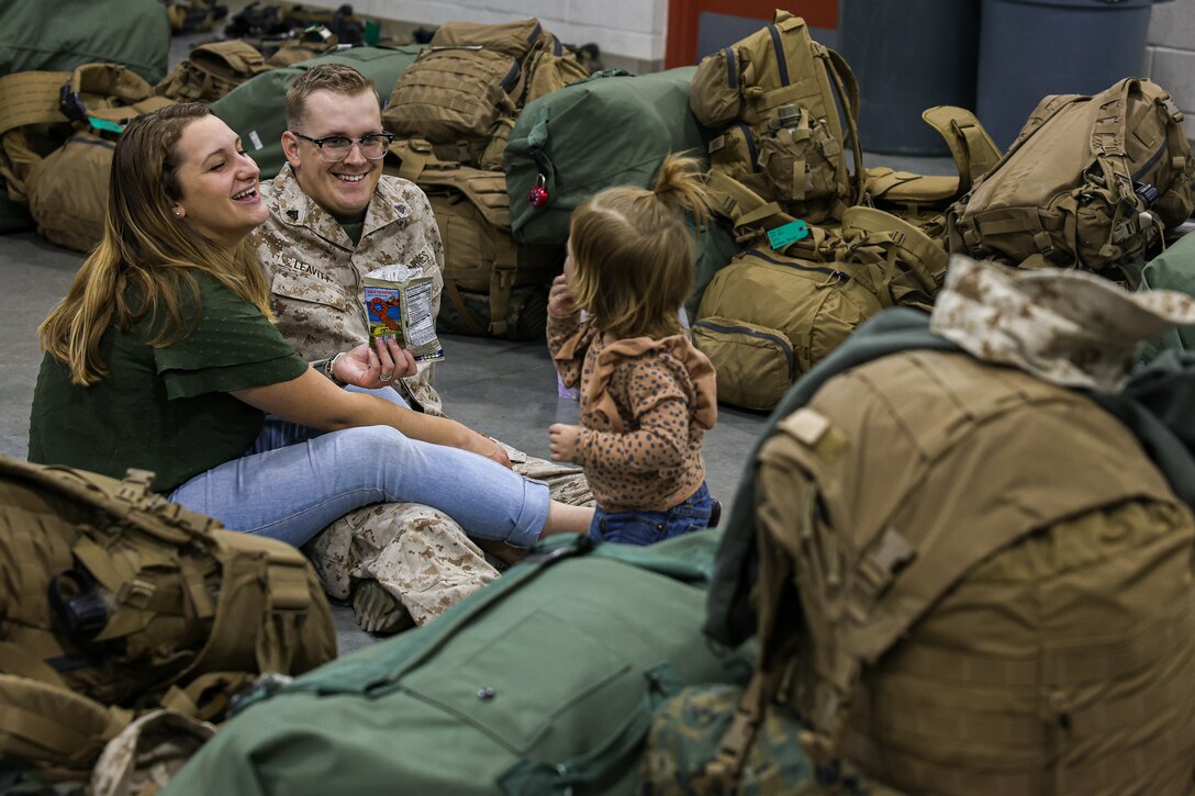 U.S. Marine Corps Cpl. Chaison Leavitt, machine gunner with Fox Company, 2nd Battalion, 23d Marine Regiment, 4th Marine Division, spends time with his wife and daughter before activating for the unit deployment program at Camp Williams, Utah, Nov. 3, 2024. The activation marks the beginning of an intensive period of training for 2nd Battalion 23d Marines as they provide a total force solution in support of the UDP by aligning Marine Forces Reserve’s commitment to Marine Corps strategic objectives. This marks the first time since 2020 that an entire Reserve infantry battalion has activated to support the Unit Deployment Program. (U.S. Marine Corps photo by Cpl. Aaron TorresLemus)