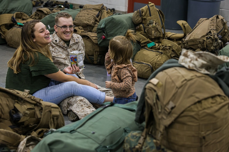 U.S. Marine Corps Cpl. Chaison Leavitt, machine gunner with Fox Company, 2nd Battalion, 23d Marine Regiment, 4th Marine Division, spends time with his wife and daughter before activating for the unit deployment program at Camp Williams, Utah, Nov. 3, 2024. The activation marks the beginning of an intensive period of training for 2nd Battalion 23d Marines as they provide a total force solution in support of the UDP by aligning Marine Forces Reserve’s commitment to Marine Corps strategic objectives. This marks the first time since 2020 that an entire Reserve infantry battalion has activated to support the Unit Deployment Program. (U.S. Marine Corps photo by Cpl. Aaron TorresLemus)