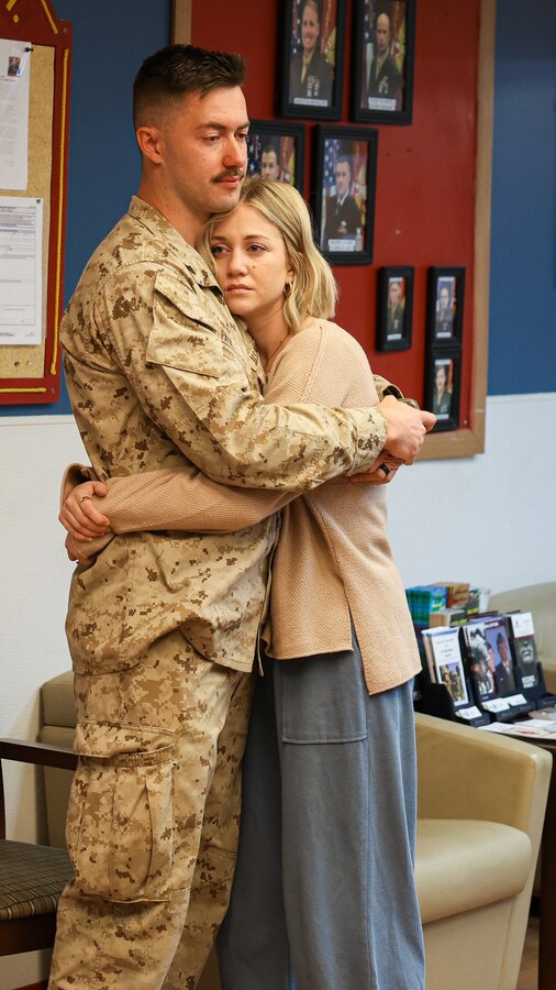 U.S. Marine Corps Cpl. Hayden Paul, infantry rifleman with Fox Company, 2nd Battalion, 23rd Marine Regiment, 4th Marine Division, hugs his wife before he leaves for the unit deployment program at Camp Williams, Utah, Nov. 3, 2024. The activation marks the beginning of an intensive period of training for 2nd Battalion, 23rd Marines as they provide a total force solution in support of the UDP by aligning Marine Forces Reserve’s commitment to Marine Corps strategic objectives. This marks the first time since 2020 that an entire Reserve infantry battalion has activated to support the Unit Deployment Program. (U.S. Marine Corps photo by Cpl. Aaron TorresLemus)