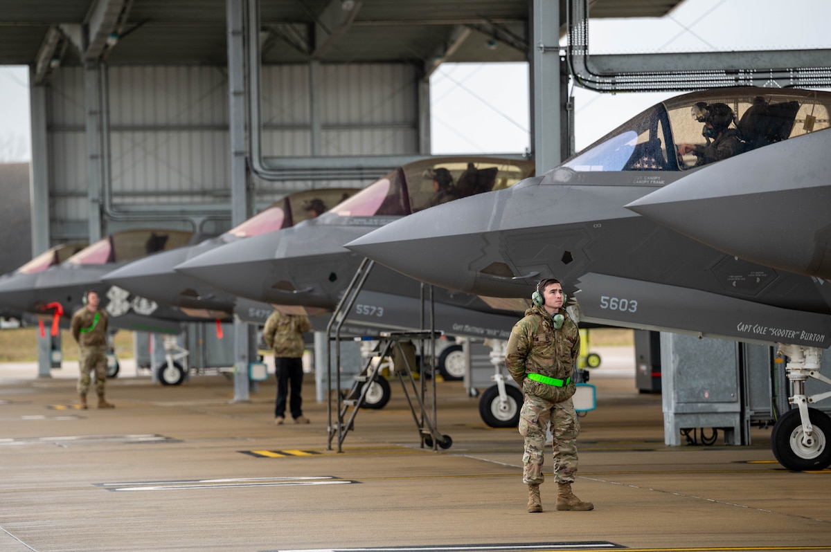an assistant dedicated crew chief stands by in preparation to launch an F-35 at RAF Lakenheath