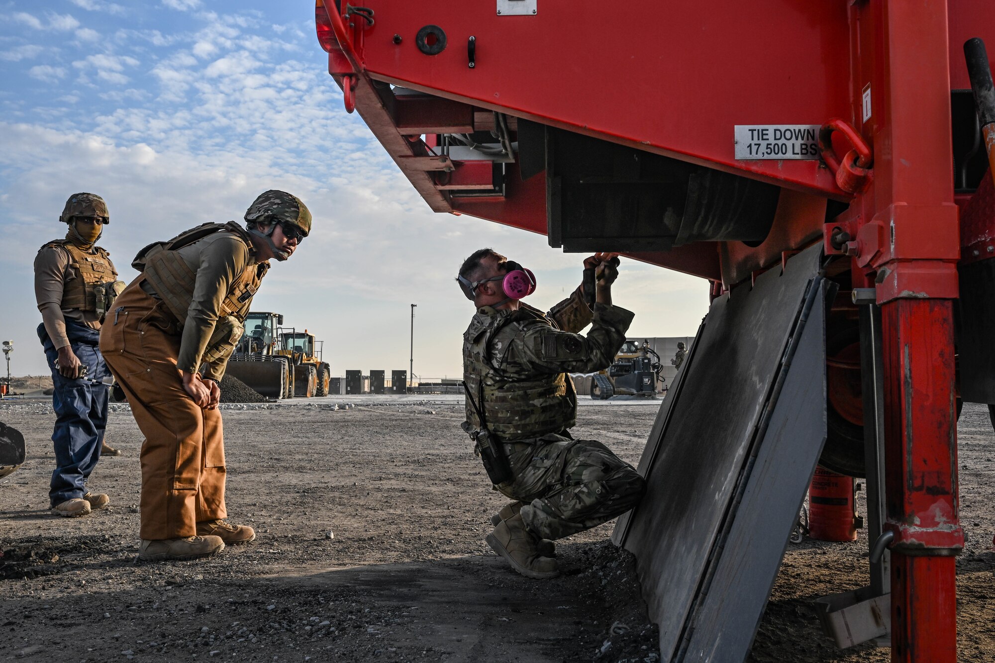 An Airman prepares a piece of equipment for operation during an exercise.