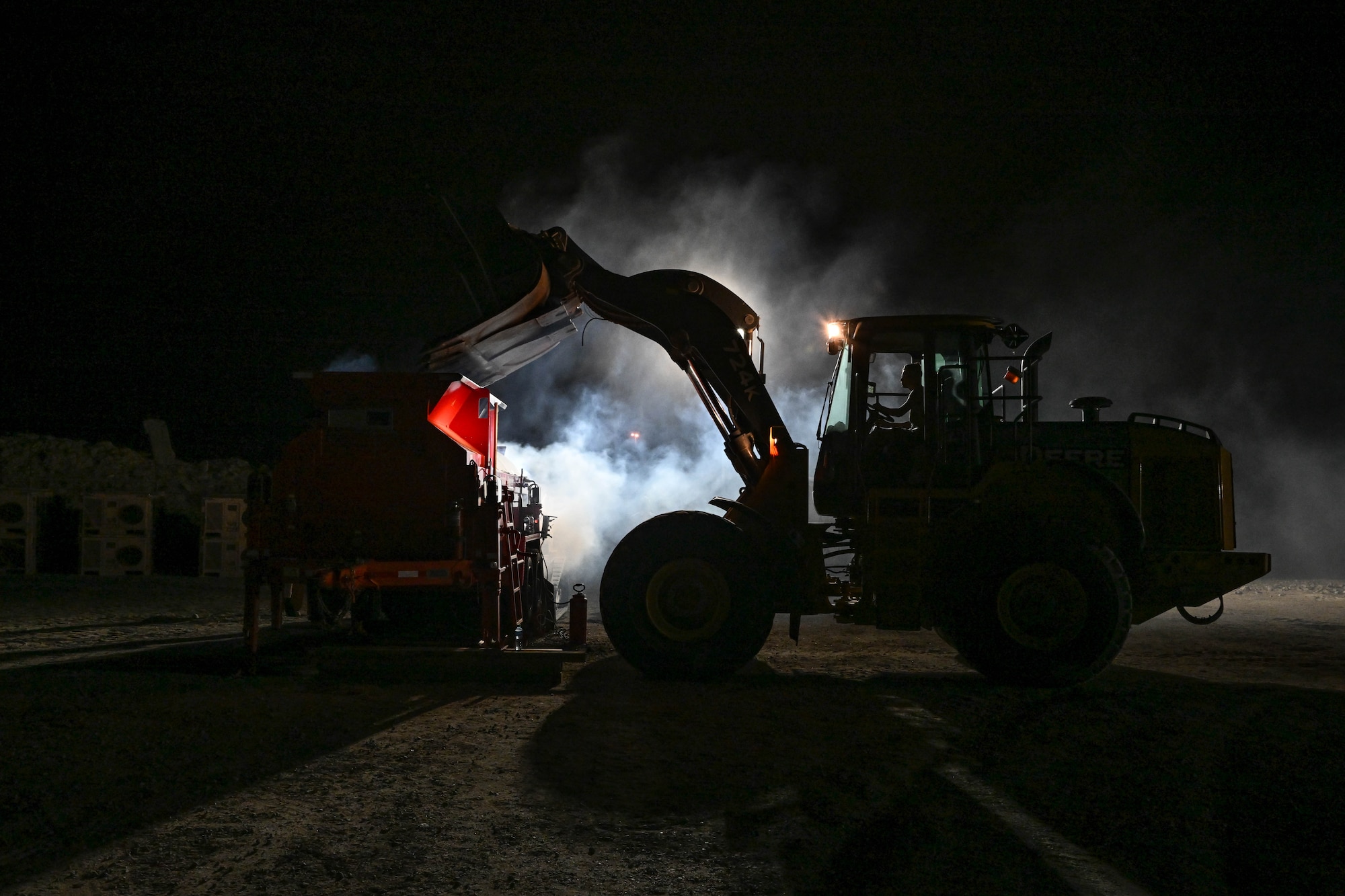 An Airman operates heavy equipment during an evening exercise.