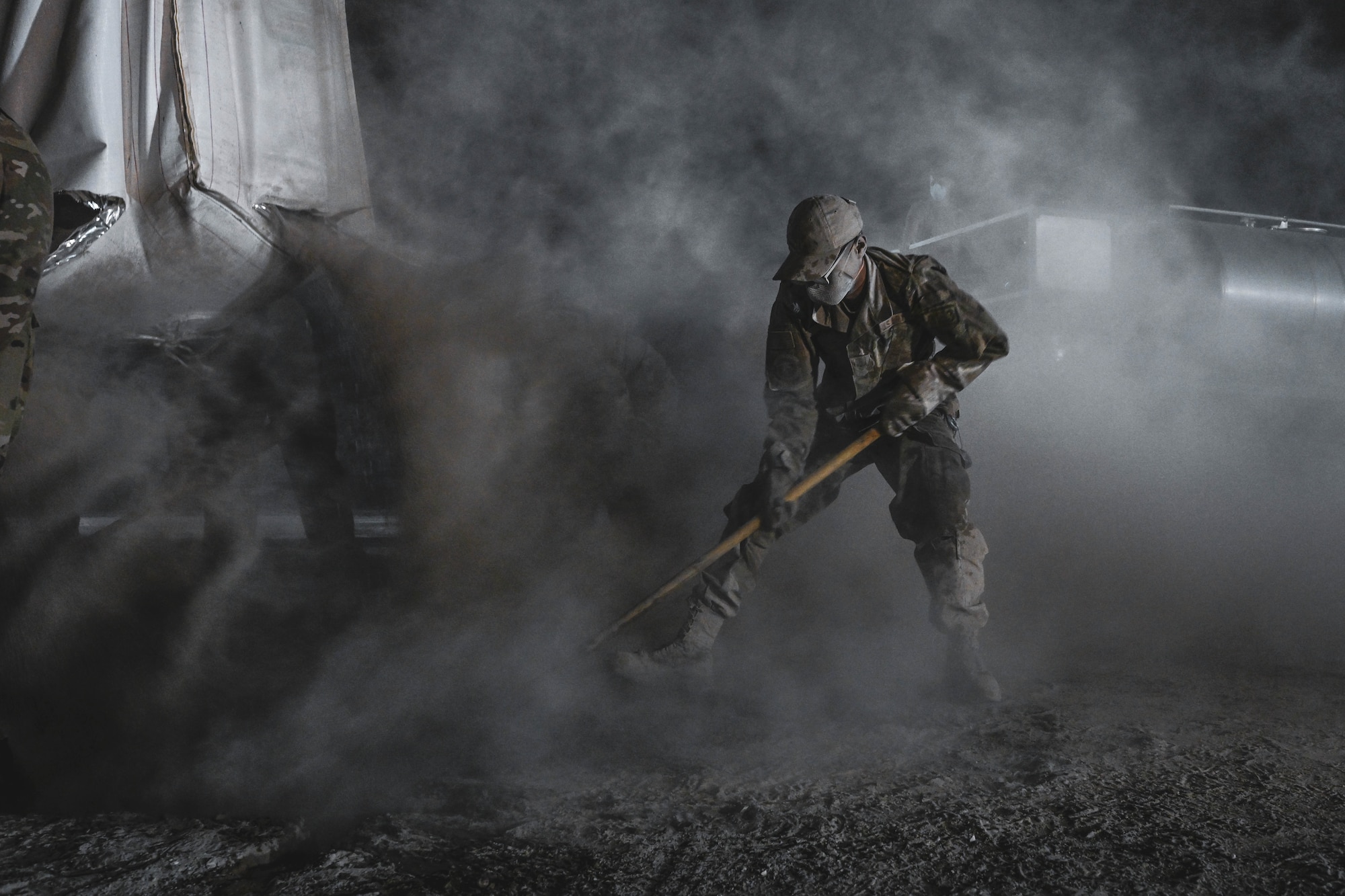 An Airman mixes concrete during an exercise.