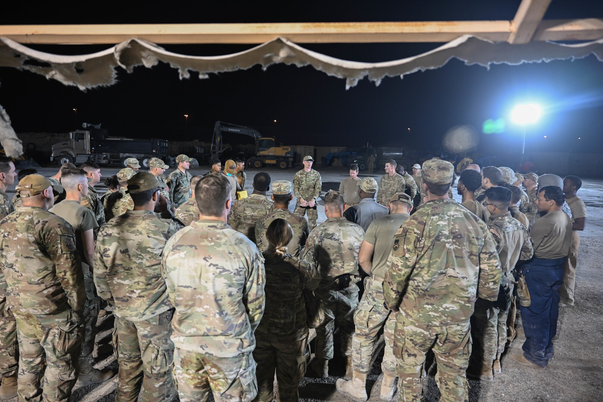 Airmen in uniform gather around after an exercise.