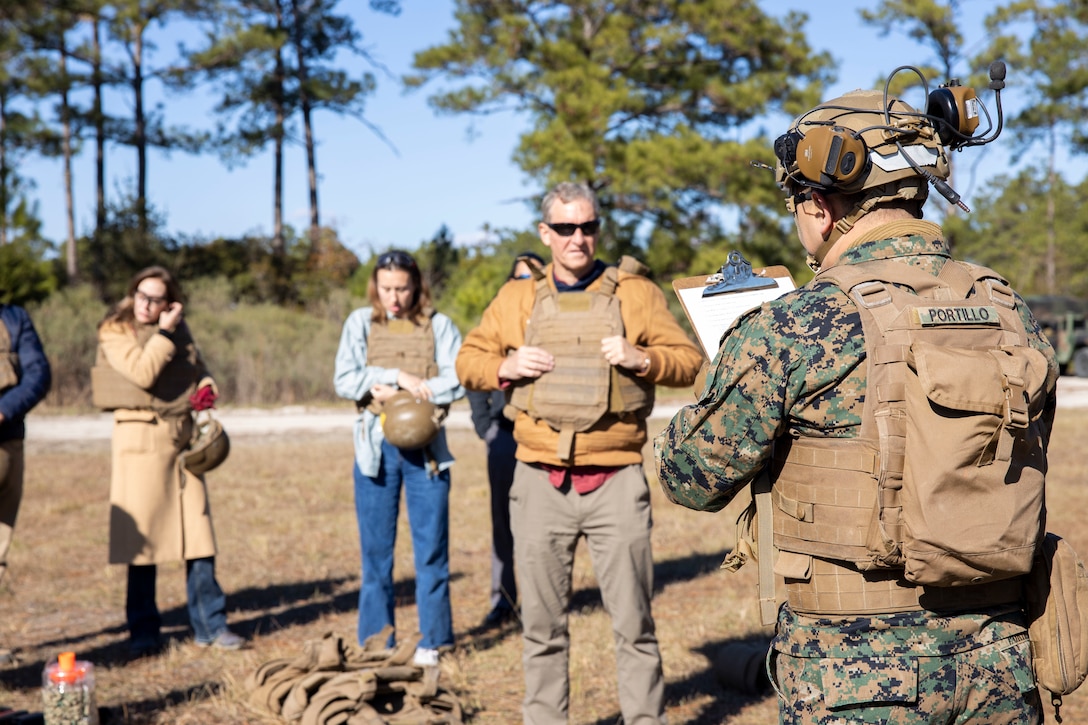 U.S. Marine Corps Master Sgt. Jose Portillo, right, operations chief with Advance Infantry Battalion, School of Infantry East Training Command, gives a safety brief during a tour at Marine Corps Base Camp Lejeune, North Carolina, Dec. 2, 2024. The Congressional Delegation (CODEL) was a bi-partisan visit consisting of House Appropriations Subcommittee on Defense (HAC-D) representatives who learned more about II MEF operations, capabilities and address issues related to DoD appropriations in North Carolina. (U.S. Marine Corps photo by Sgt. Jacquilyn Davis)