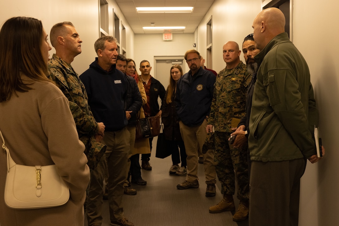 U.S. Marine Corps Col. David Fitzsimmons, right, commanding officer, Marine Air Group 29, 2nd Marine Aircraft Wing, gives a brief during a base tour at Marine Corps Air Station New River, North Carolina, Dec. 2, 2024. The Congressional Delegation (CODEL) was a bi-partisan visit consisting of House Appropriations Subcommittee on Defense (HAC-D) representatives who learned more about II MEF operations, capabilities and address issues related to DoD appropriations in North Carolina. (U.S. Marine Corps photo by Cpl. Maurion Moore)