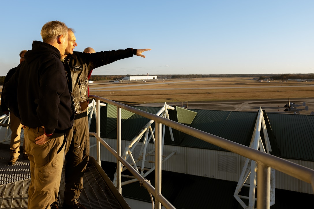 U.S. Marine Corps Lt. Col. William Oren, right, installation and environment director, Marine Corps Air Station New River, and U.S. House of Representative Matt Cartwright (D-PA), left, observe the flight line during a tour of Marine Corps Air Station New River, North Carolina, Dec. 2, 2024. The Congressional Delegation (CODEL) was a bi-partisan visit consisting of House Appropriations Subcommittee on Defense (HAC-D) representatives who learned more about II MEF operations, capabilities and address issues related to DoD appropriations in North Carolina. (U.S. Marine Corps photo by Cpl. Maurion Moore)