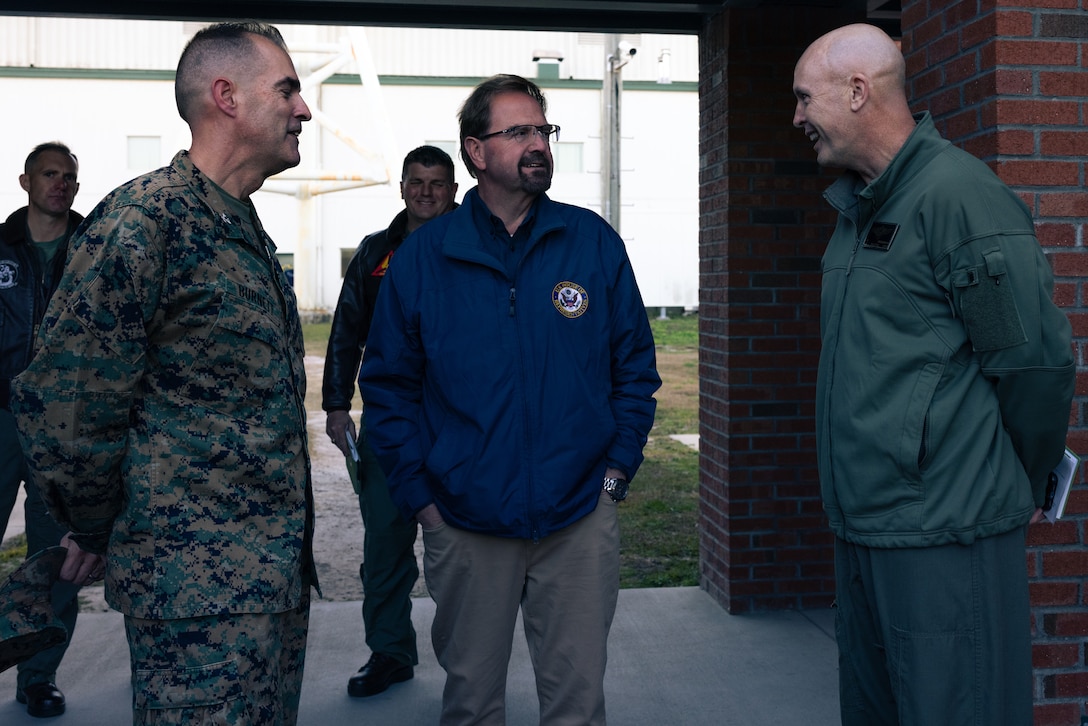 U.S. Marine Corps Col. Garth Burnett, left, commanding officer, Marine Corps Air Station New River, Col. David Fitzsimmons, right, commanding officer, Marine Air Group 29, 2nd Marine Aircraft Wing, and U.S. House of Representative Chuck Edwards (R-NC), center, discuss during a tour at Marine Corps Air Station New River, North Carolina, Dec. 2, 2024. The Congressional Delegation (CODEL) was a bi-partisan visit consisting of House Appropriations Subcommittee on Defense (HAC-D) representatives who learned more about II MEF operations, capabilities and address issues related to DoD appropriations in North Carolina. (U.S. Marine Corps photo by Cpl. Maurion Moore)