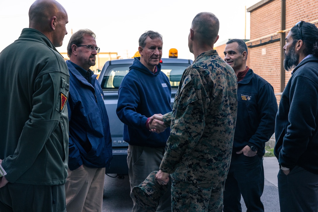 U.S. Marine Corps Col. Garth Burnett, center-right, commanding officer, Marine Corps Air Station New River, and U.S. House of Representative Matt Cartwright (D-PA), center-left, shake hands during a tour at Marine Corps Air Station New River, North Carolina, Dec. 2, 2024. The Congressional Delegation (CODEL) was a bi-partisan visit consisting of House Appropriations Subcommittee on Defense (HAC-D) representatives who learned more about II MEF operations, capabilities and address issues related to DoD appropriations in North Carolina. (U.S. Marine Corps photo by Cpl. Maurion Moore)