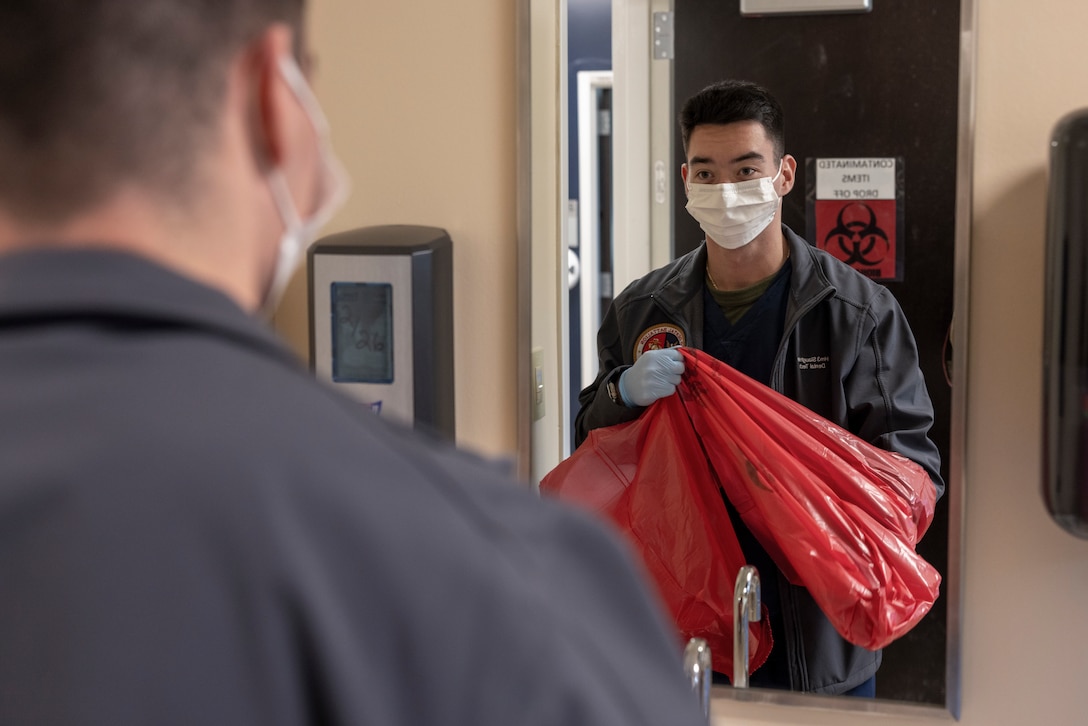 U.S. Navy Hospital Corpsman 3rd Class Cody Slaughter, a dental assistant with 2nd Dental Battalion, 2nd Marine Logistics Group, and a native of Abilene, Texas, opens biohazard bags on Camp Lejeune, North Carolina, Dec. 5, 2024. Slaughter was selected as warrior of the week for his dedication, leadership and work ethic that his command says sets him apart from his peers, ensuring mission success. When asked about his favorite part of his job, Slaughter said, “I think my favorite part of my job is interacting with the patients. It is rewarding to see someone who wasn’t confident in their smile, get up and look in the mirror after an operation and smile proudly.” Each week, 2nd MLG recognizes one outstanding Marine or Sailor that goes above and beyond in their duties and embodies the qualities of an outstanding service member. (U.S. Marine Corps photo by Cpl. Jessica J. Mazzamuto)