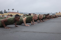 The new U.S. Marines of Kilo Company, 3rd Recruit Training Battalion, execute dynamic warm-ups prior to the company motivational run at Marine Corps Recruit Depot San Diego, California, Dec. 5, 2024. The company motivational run is a three-mile cadence run conducted around the Depot and is the last physical training event the Marines will conduct before they graduate from MCRD San Diego. The event is also the first-time friends and families will see their newly transformed Marines. (U.S. Marine Corps photo by Lance Cpl. Jacob Hutchinson)