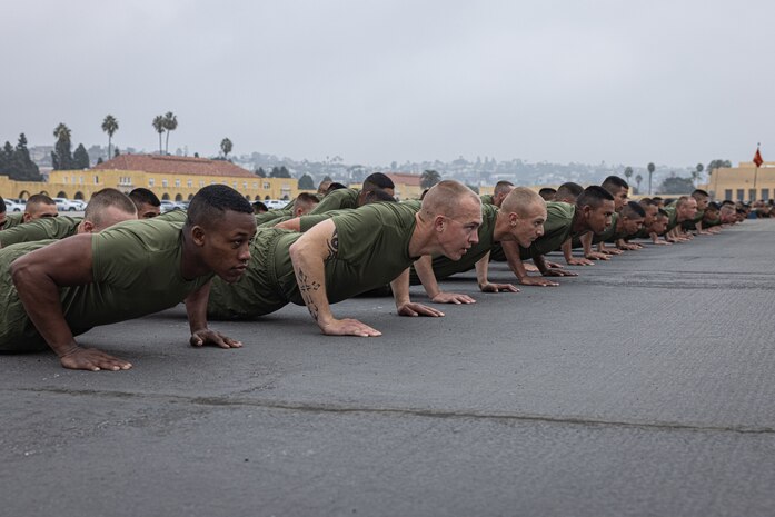 The new U.S. Marines of Kilo Company, 3rd Recruit Training Battalion, execute dynamic warm-ups prior to the company motivational run at Marine Corps Recruit Depot San Diego, California, Dec. 5, 2024. The company motivational run is a three-mile cadence run conducted around the Depot and is the last physical training event the Marines will conduct before they graduate from MCRD San Diego. The event is also the first-time friends and families will see their newly transformed Marines. (U.S. Marine Corps photo by Lance Cpl. Jacob Hutchinson)