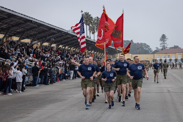 U.S. Marines with Recruit Training Regiment, Marine Corps Recruit Depot San Diego, lead a motivational run at MCRD San Diego, California, Dec. 5, 2024. The company motivational run is a three-mile cadence run conducted around the Depot and is the last physical training event the Marines will conduct before they graduate from MCRD San Diego. The event is also the first-time friends and families will see their newly transformed Marines. (U.S. Marine Corps photo by Lance Cpl. Jacob Hutchinson)