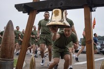 A new U.S. Marine of Kilo Company, 3rd Recruit Training Battalion, rings the liberty bell during the company motivational run at Marine Corps Recruit Depot San Diego, California, Dec. 5, 2024. The company motivational run is a three-mile cadence run conducted around the Depot and is the last physical training event the Marines will conduct before they graduate from MCRD San Diego. The event is also the first-time friends and families will see their newly transformed Marines. (U.S. Marine Corps photo by Lance Cpl. Jacob Hutchinson)