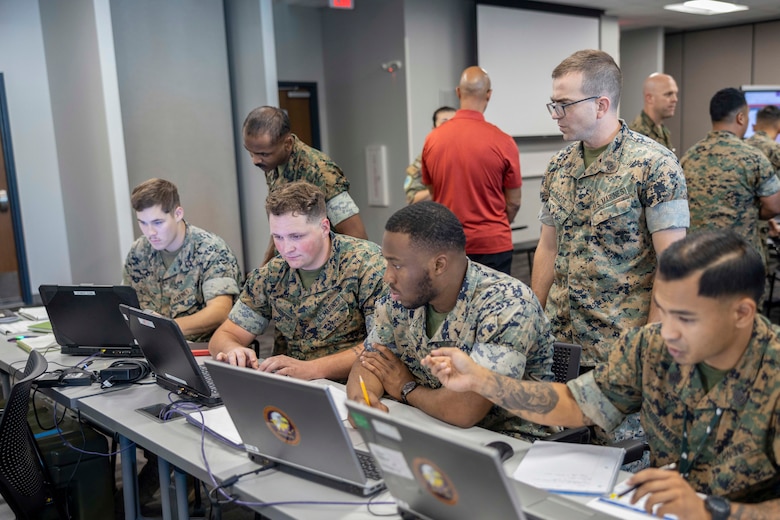U.S. Marines with 2d Air Naval Gunfire Liaison Company (ANGLICO), II MEF, discuss the events of Island Marauder as part of Bold Quest '24 at Marine Corps Base Camp Lejeune, North Carolina, Oct. 30, 2024. Bold Quest '24 is a joint staff sponsored, multinational venue designed to enhance and develop interoperability.