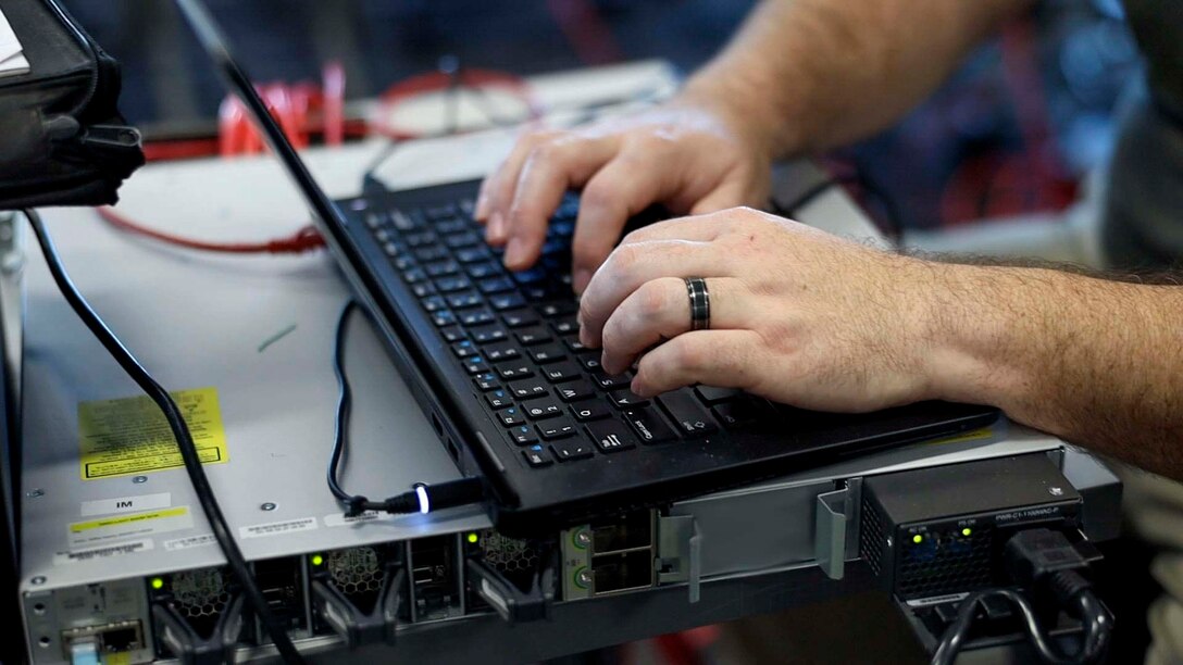 Josh Henderson, a technician, with the Naval Information Warfare Center, works at his computer during Island Marauder as part of Bold Quest '24 at Marine Corps Base Camp Lejeune, North Carolina, Oct. 30, 2024. Bold Quest '24 is a joint staff sponsored, multinational venue designed to enhance and develop interoperability.