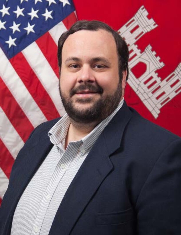 Picture of a man in front of a flag