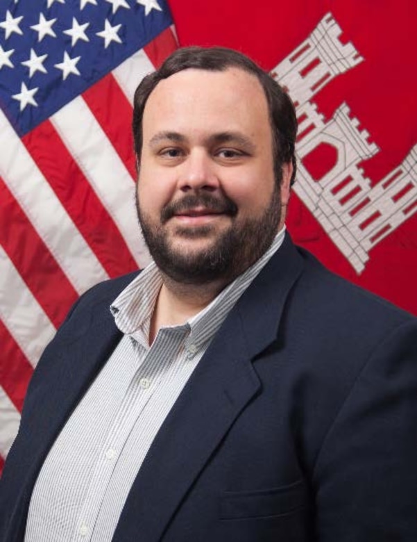 Picture of a man in front of a flag