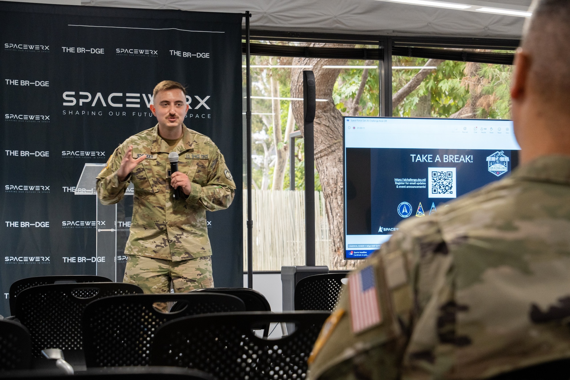 USSF Capt. Jake Schneider, Chief of Portfolio, Platform, at Space Systems Command (SSC), addresses participants in the inaugural U.S. Space Force Generative AI Challenge. The hybrid-virtual, hack-a-thon like competition kicked off on Sept. 12 and ran for eight weeks. Registered teams were challenged to create solutions to Space Force problem statements leveraging generative AI.