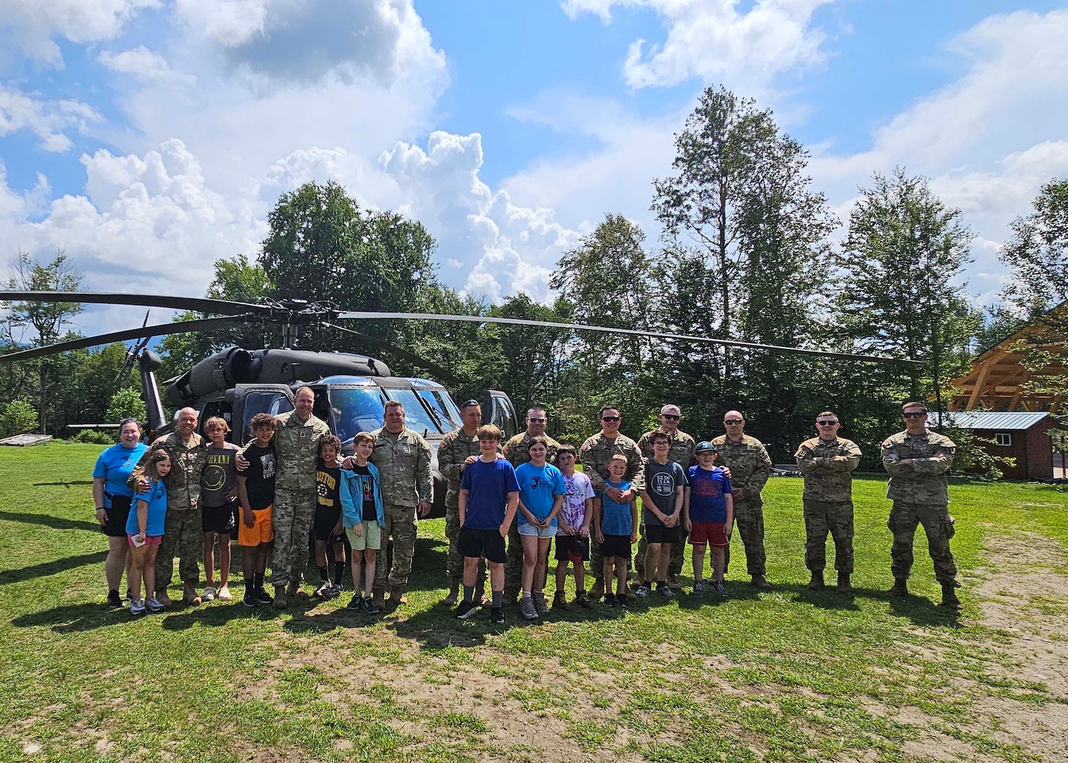 Campers and staff of Copper Cannon Camp mingle with New Hampshire Guardsmen and tour a 238th Medevac Company Black Hawk helicopter on Aug. 1, 2024, in Bethlehem, N.H.