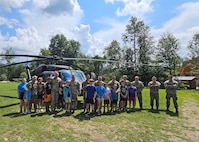 Campers and staff of Copper Cannon Camp mingle with New Hampshire Guardsmen and tour a 238th Medevac Company Black Hawk helicopter on Aug. 1, 2024, in Bethlehem, N.H.